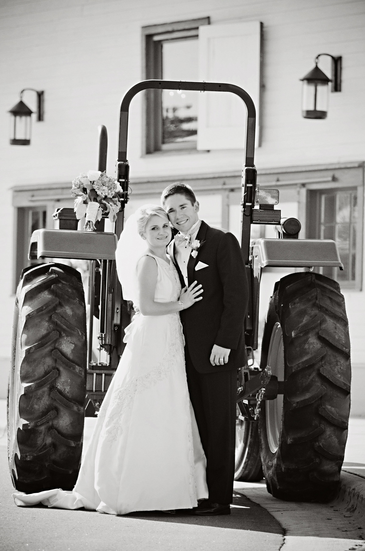 Cedar Falls couple at reception in front of John Deere tractor