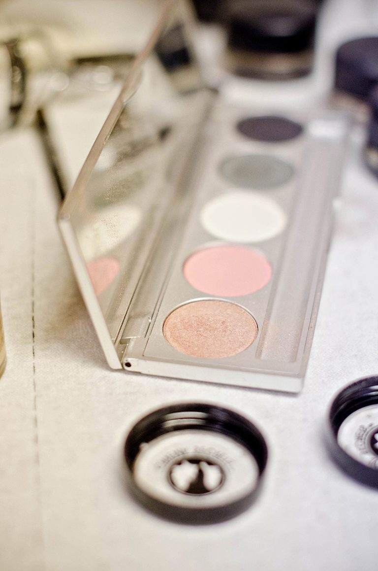 professional makeup artist's eye palette open for makeup application