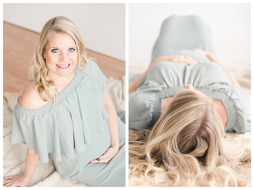 maternity photos in natural light studio with mom sitting and cradling her belly