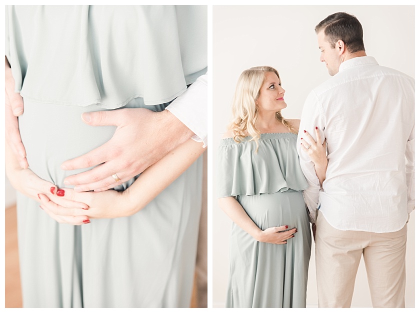 Maternity coupling smiling at each other and holding mom's belly by Meghan Goering Photography