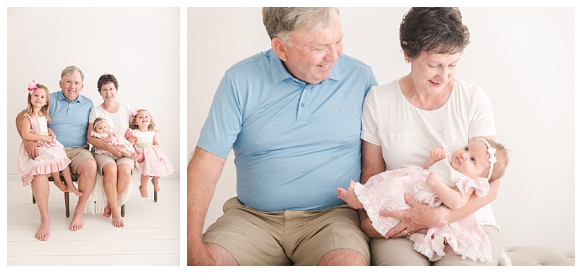 grandparents holding newborn granddaughter