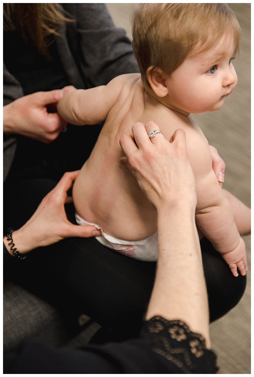 newborn being checked by chiropractor dr sara cahill