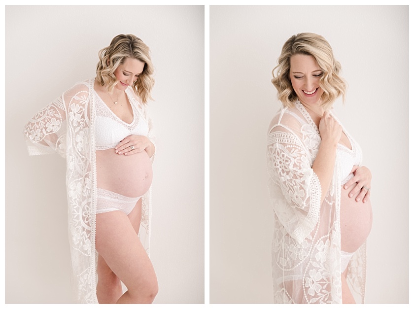 maternity client posing for intimate boudoir photos in light and airy studio wearing white bralette and lacey panties
