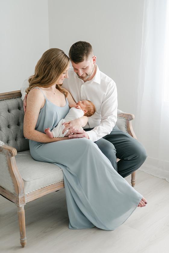 beautiful iowa city couple with newborn at light and airy photography studio