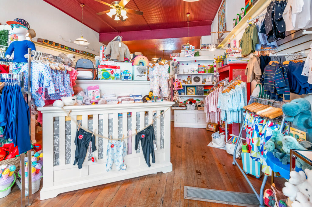 A large selection of infant and children's clothing on display at Peekaboo Baby