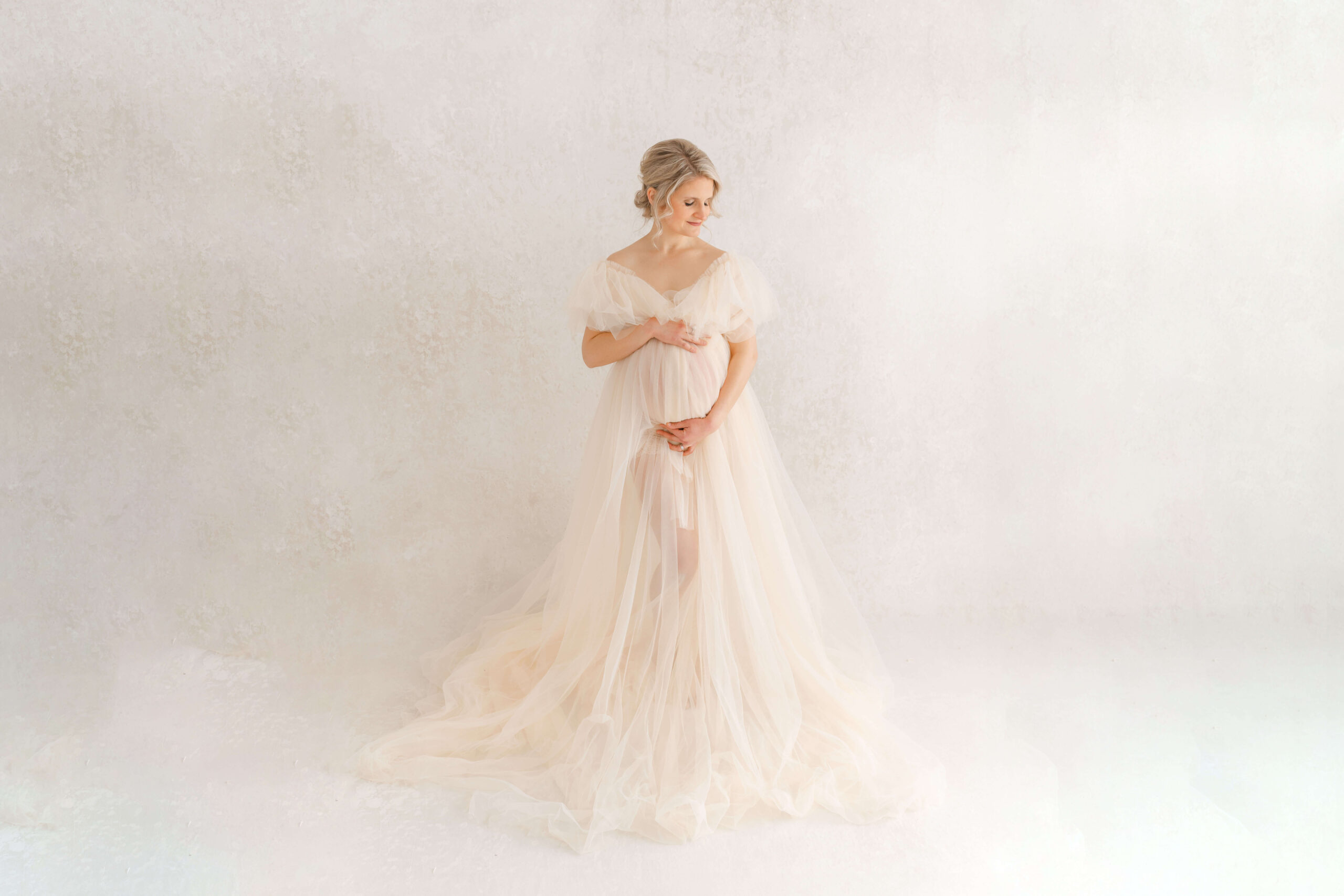glamorous maternity photoshoot with custom tulle maternity gown against hand painted backdrop by JRD artshop